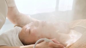 attractive asian woman taking facial treatment