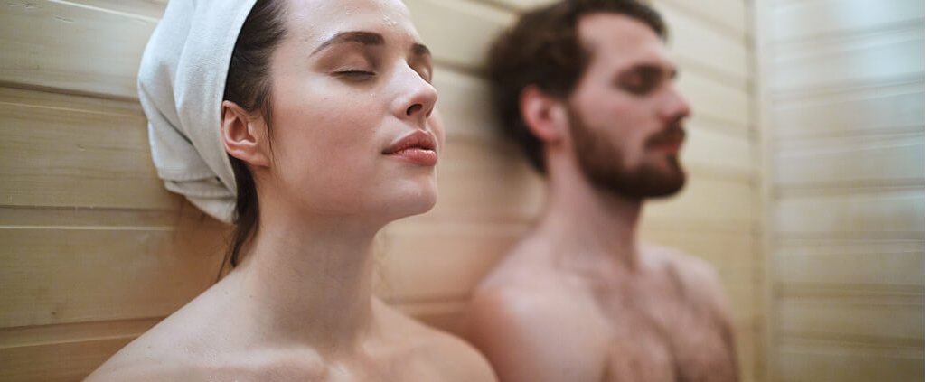 a man and a woman are having a rest after taking a sauna shower